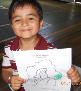 A boy in San Juan Sur shows off his coloring page of Jesus' ascension.